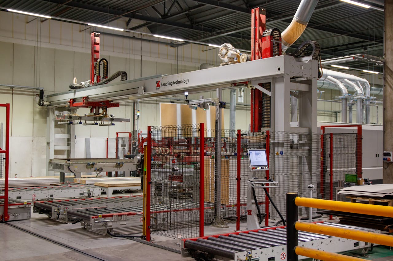 gallery-01 Industrial machinery with robotic arm in a modern manufacturing facility.