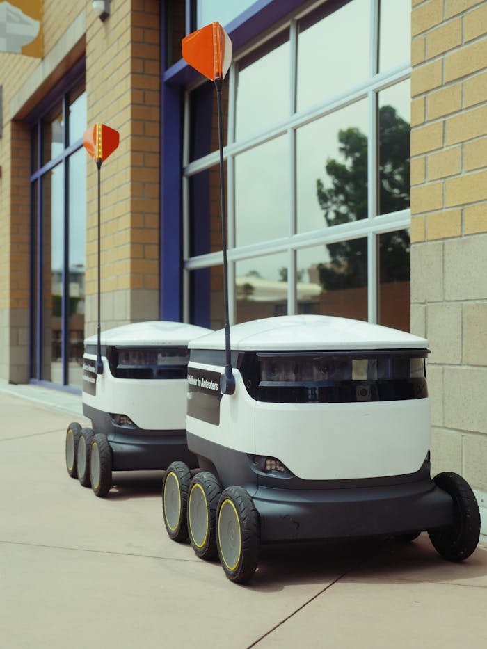 Futuristic food delivery robots operating autonomously outdoors.